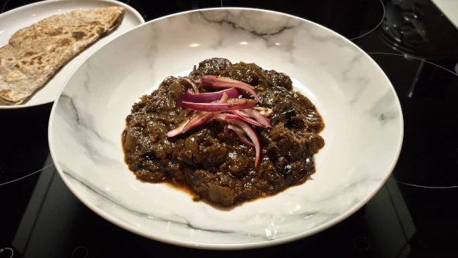 beef vindaloo and pickled onion plated