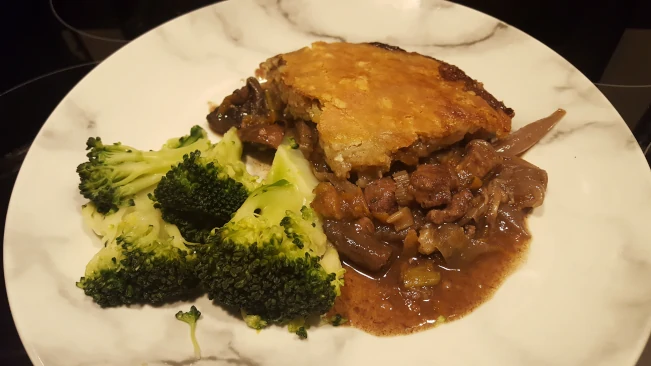 pie and broccoli served on a plate pie and broccoli plated 1