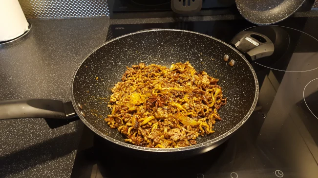 mince and spices cooking in a pan mince spices in pan