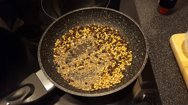 Toasting whole spices gently in a pan to release their natural oils whole spices toasting