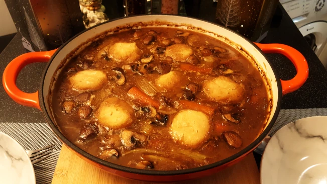 beef stew and dumplings in cast iron cooking pot beef stew and dumplings cooked