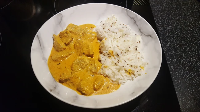 butter chicken served with jeera rice butter chicken and jeera rice