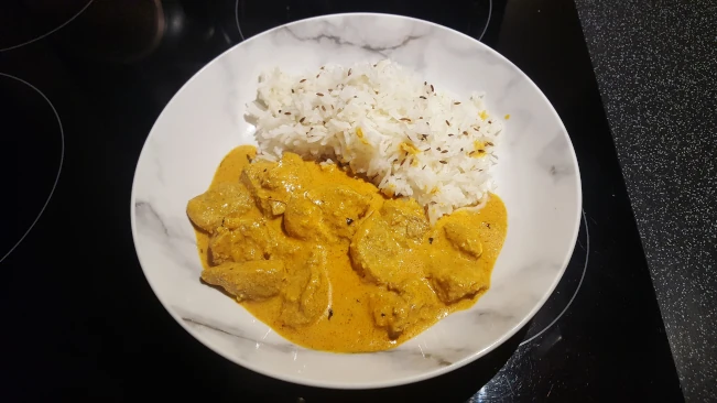 butter chicken served with jeera rice butter chicken and jeera rice