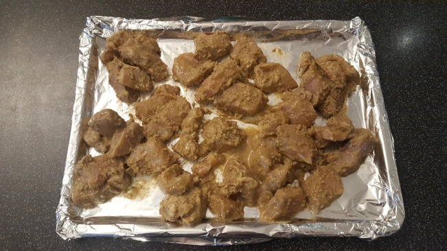 marinated chicken chunks on a tray for butter chicken marinated chicken chunks on tray