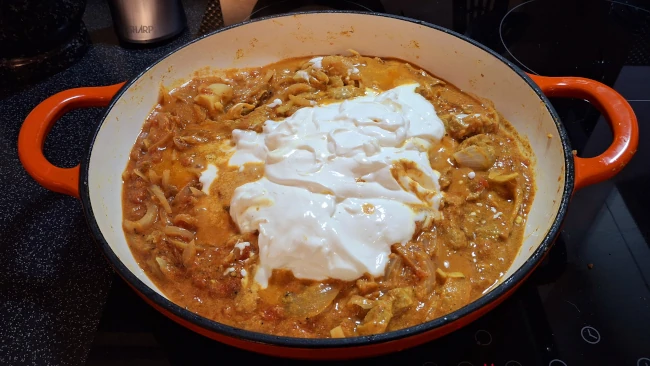 yogurt added to ingredients in pan