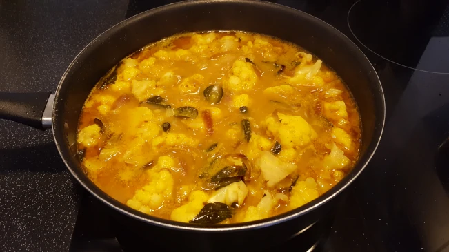 water and coconut milk added to make cauliflower curry add water and coconut milk