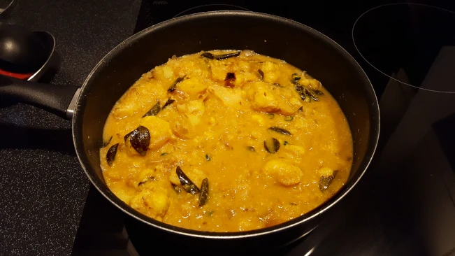cauliflower curry finished cooking in a pan cauliflower curry in a pan