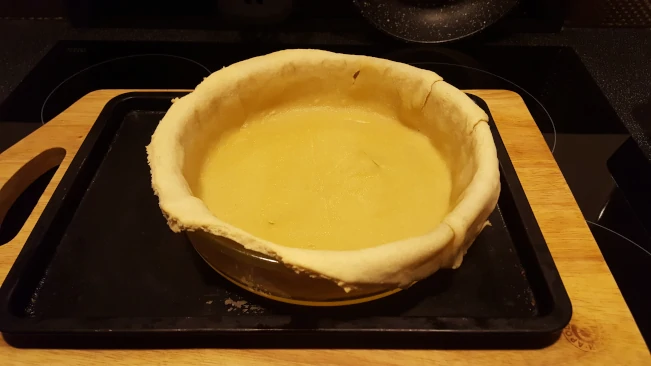 pastry base part baked with rice and paper removed pastry base blind baked