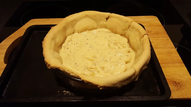 sauce added as the first layer of the pie pastry base filling 1