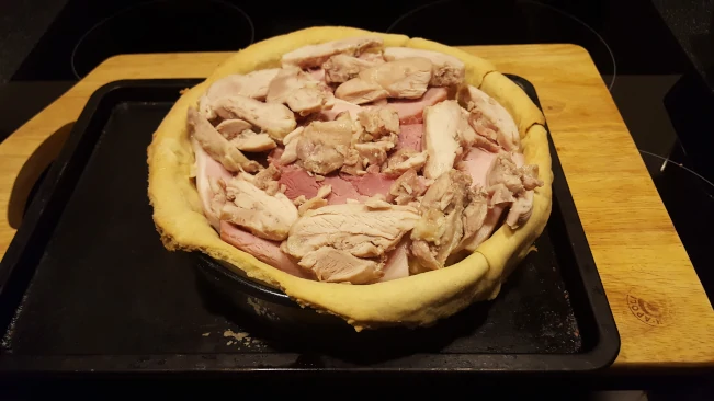 making layers of meat & sauce pastry base filling 6