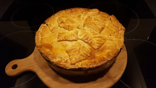 chicken & gammon pie cooling on a board pie cooked trimmed