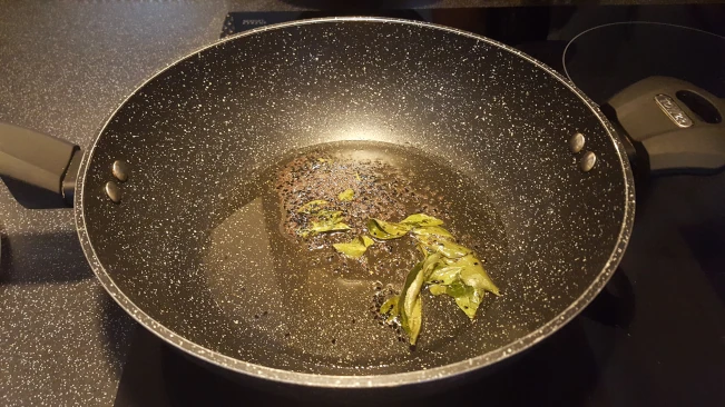 mustard and onion seeds frying with curry leaves 01
