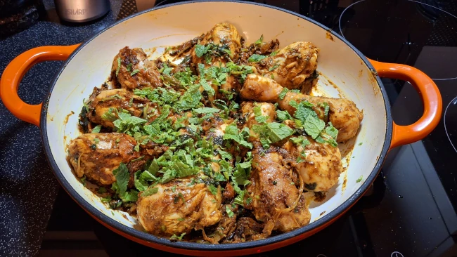 chopped mint added to chicken in wok for chicken biryani chopped mint added to chicken