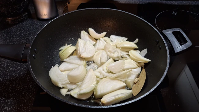 onions added to pan for chicken biryani onions added to pan