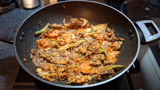 tomatoes blended with ingredients in wok for chicken biryani tomatoes blended with ingredients in wok