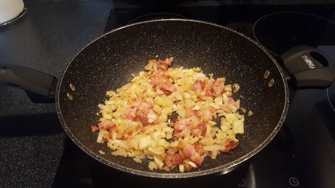 onions softening with bacon for chicken in creamy peppercorn sauce onions softening with bacon