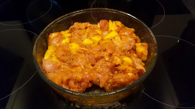 chicken marinating in a dish