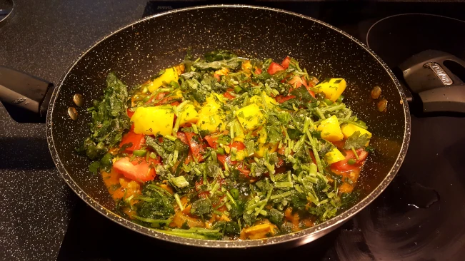 fresh ingredients added to curry