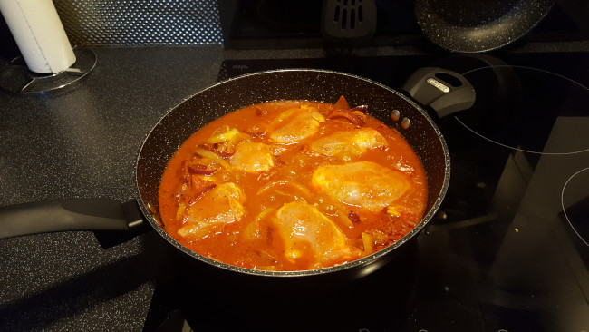chicken cooking in pan