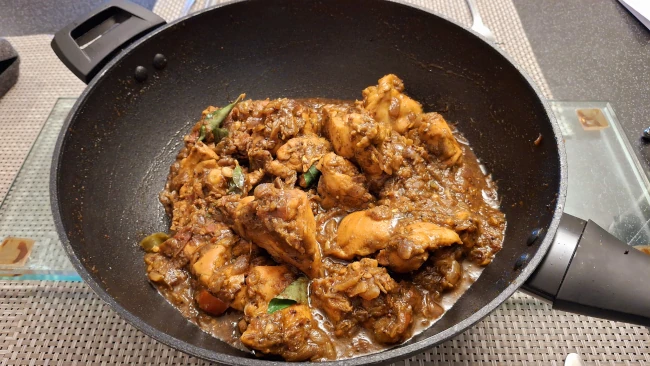 curry leaf masala chicken fry cooked in a wok & ready to serve curry leaf masala cooked in a wok