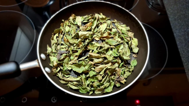 curry leaves drying in a pan for curry leaf masala chicken fry curry leaves drying in a pan