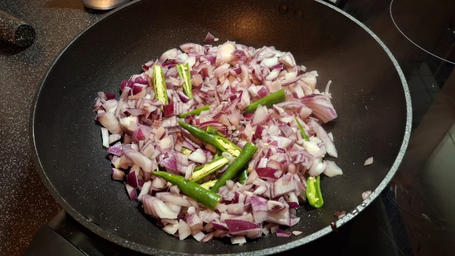onions chiiies in a pan for curry leaf masala chicken fry onions chiiies in a pan