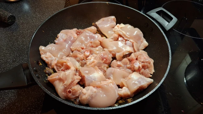 raw chicken added to pan for curry leaf masala chicken fry raw chicken added to pan