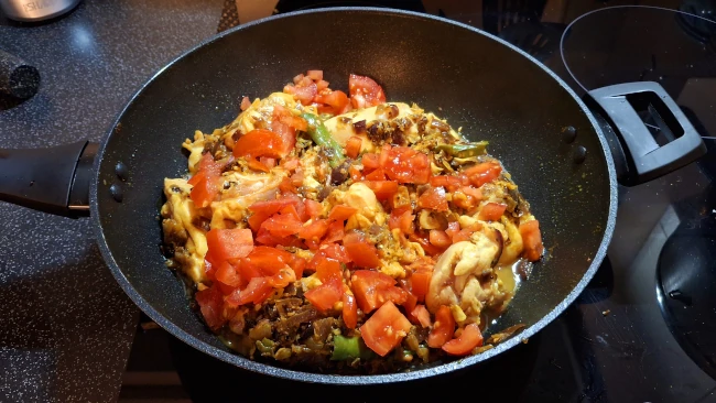 tomatoes added to pan for curry leaf masala chicken fry tomatoes added to pan