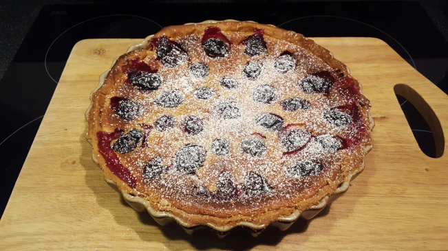 damson and soured ceam tart dusted with icing sugar damson and soured cream tart