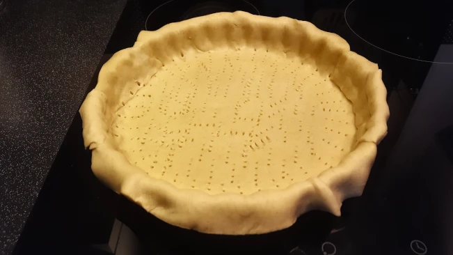 raw pastry in a flan dish for damson and soured ceam tart raw pastry in a flan dish