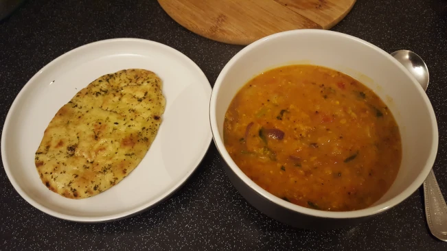 dhal with fried spices served with naan dhal and naan served