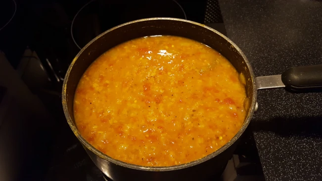 dhal and tomatoes in pan for dhal with fried spices dhal and tomatoes in pan
