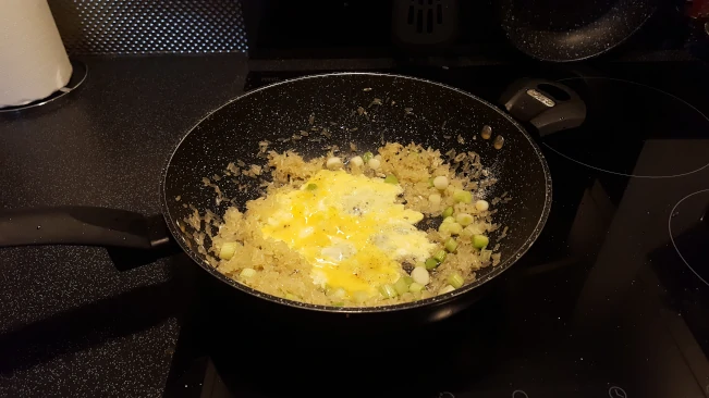 egg tipped into the middle of the rice add egg to the rice