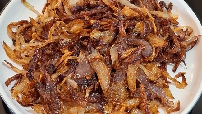 a pile of cooked browned onion slices on a plate