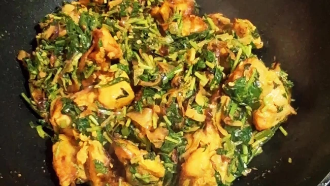 fenugreek chicken cooking in a pan
