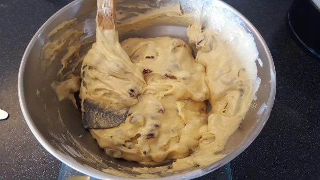 mixing fruit into the fruit cake batter mixed fruit added to cake batter