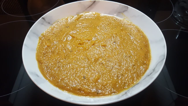 stock added to roasting dish for Jamaican Pumpkin Soup stock added to roasting dish