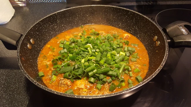add spring onion tops 02 to jerked chicken curry add spring onion tops 02
