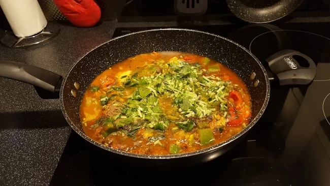 coriander added to finish the karahi chicken curry coriander added to karahi chicken curry