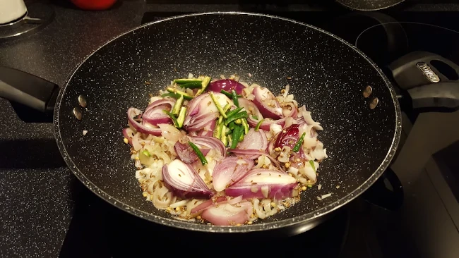 onions spice seeds green chilli in a wok onions spice seeds green chilli