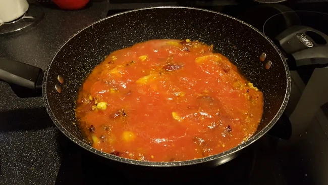 tomatoes added to the wok tomatoes added