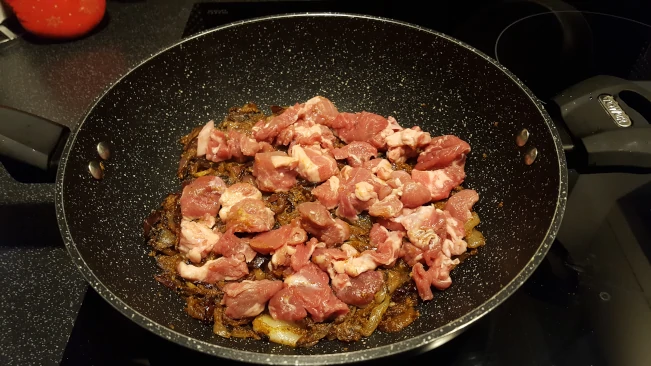 lamb added to onions & spices lamb added to pan