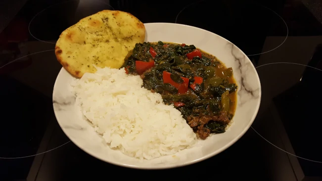 lamb curry with spinach rice and naan in a dish lamb curry with spinach rice and naan 2