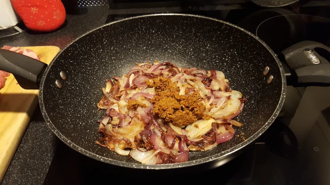 spice paste added for lamb curry with spinach spice paste added to onions