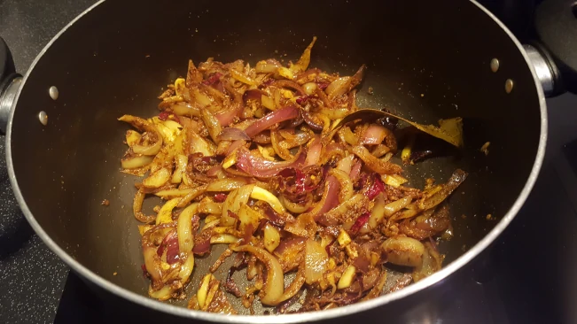 onions and spices cooking for lamb kofta curry onions and spices cooking