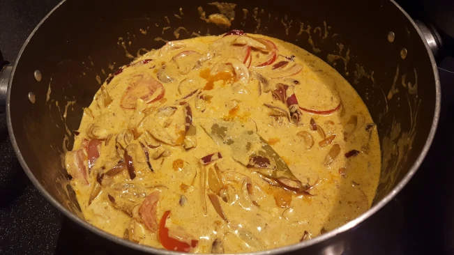 green chillies and yogurt added to onions for lamb kofta curry yogurt added to onions