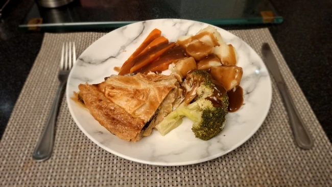 luxury chicken, mushroom & leek pie with veg & gravy on a plate pie veg and gravy on a plate