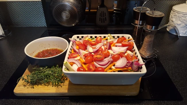 ingredients in oven dish for Mediterranean style vegetables with pork steaks ingredients in oven dish