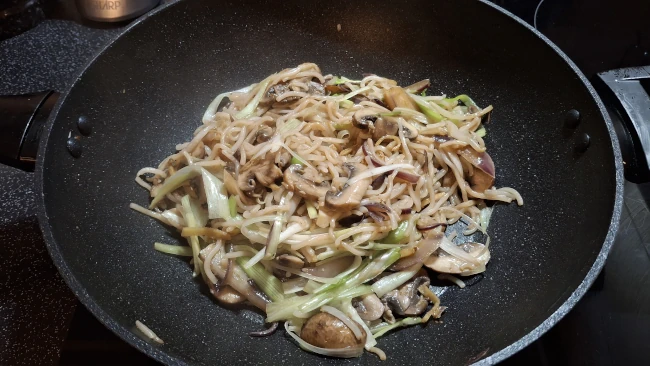 mushroom chow mein frying in a wok mushroom chow mein frying