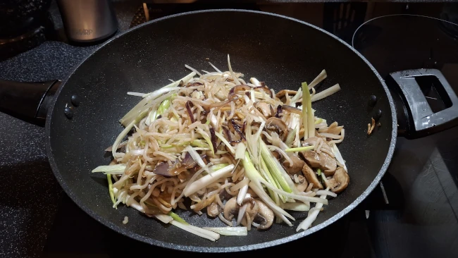 mushroom chow mein frying in a wok mushroom chow mein frying